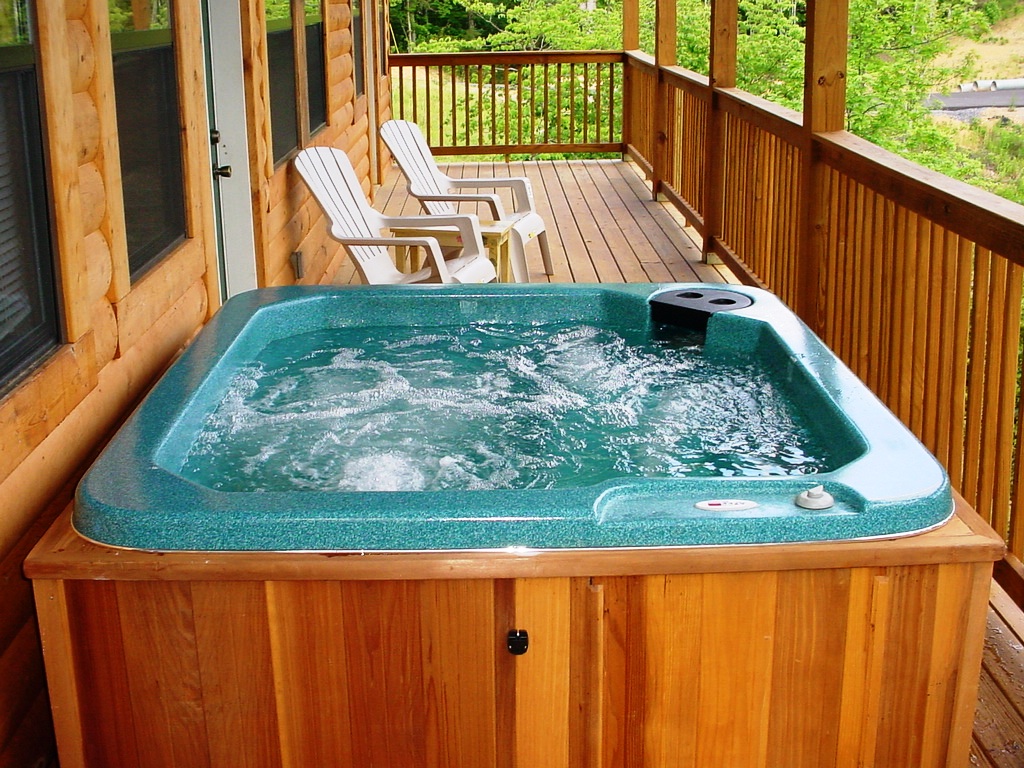 hot tub that over looks a mountain view and wooded scenery